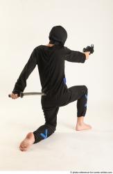 VLASTIMIL KNEELING POSE WITH GUN